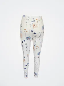 Back view of white leggings with delicate blue and orange floral print patterns.