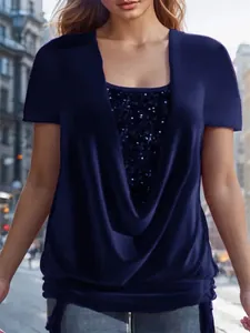 Detail of blue faux two-piece top with sequin insert and elegant drape neck design