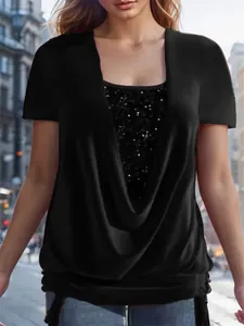Close-up of shimmering sequin insert and elegant drape neck on this black two-piece style top.
