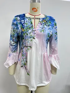 Detailed view of women's floral V-neck pleated shirt with elegant white buttons