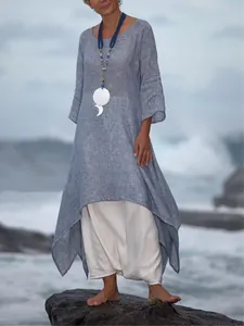 Bohemian loose blue linen maxi dress with asymmetrical hem on ocean background
