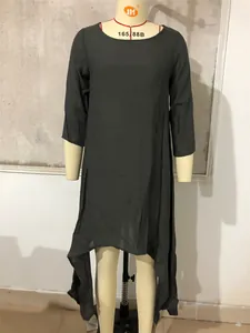 Detail view of loose cotton linen black dress with asymmetrical hem on mannequin