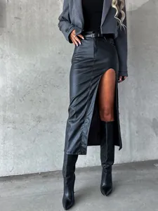 Close-up detail of a black high-slit faux leather midi skirt with an included waist belt