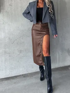 Sophisticated brown faux leather midi skirt featuring a high side slit for a chic urban look
