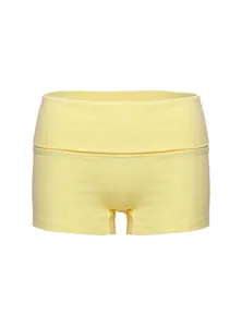 Close-up of yellow high-waisted yoga shorts with turnover waistband details