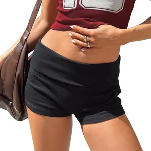 Close-up detail of slim fit black cotton yoga shorts featuring a fold-over waist design