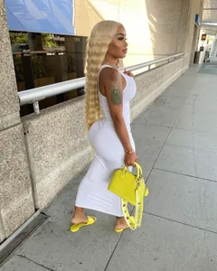 Detailed side view of a sexy white ribbed U-neck sleeveless midi dress shown on a model.
