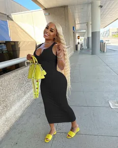 Full length view of a sexy black sleeveless ribbed midi dress with U-neck detail on model