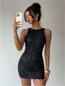 Detail view of black lace mini dress with sequin floral embroidery on a model