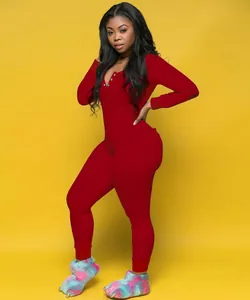 Close-up detail of women's red long-sleeved henley neck jumpsuit loungewear pajamas