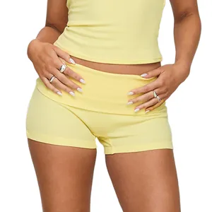Close-up of vibrant yellow yoga shorts featuring a stylish fold-over high waistband