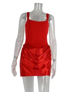 Elegant red sleeveless cocktail dress with ruched satin skirt detailing on mannequin