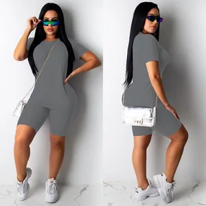 Full body detail view of grey 2-piece athletic set featuring t-shirt and biker shorts.
