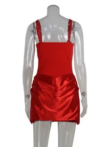 Detailed back view of a red mini dress with slim straps and a pleated satin skirt hem.
