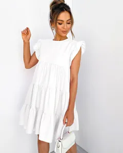 Close-up detail of a white summer tiered dress featuring elegant ruffle sleeves and round neck