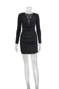 Detailed view of a black long-sleeved ruched bodycon dress with deep V cowl neck.