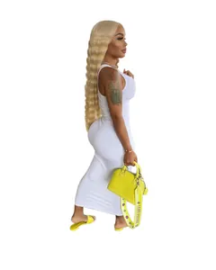 Full body view of a woman wearing a white ribbed sleeveless maxi dress with a U-neck