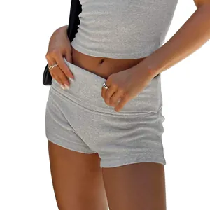 Detailed macro view of grey ribbed yoga shorts with high-waist fold-over band for gym.