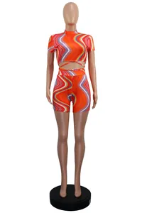 Stylish two-piece summer set featuring a vibrant orange swirl print and waist tie detail.