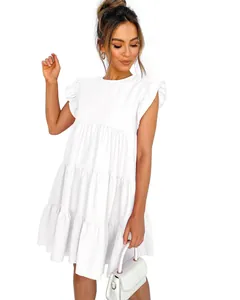 Elegant white tiered mini dress with ruffle sleeves, detailed view of summer fashion