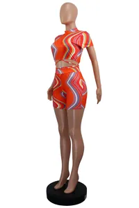 Side view of orange two-piece set featuring vibrant wavy stripes and waist ties