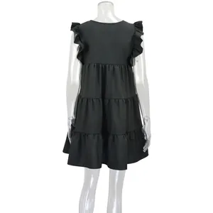 Detailed back view of a black tiered summer dress featuring elegant ruffled shoulder sleeves