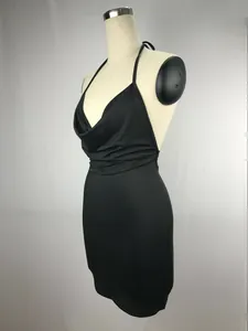 Detail side view of sexy black backless halter mini dress with cowl neck on mannequin