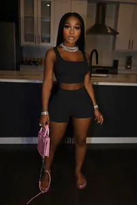 Sexy black two-piece casual set with tank top and shorts modeled in modern kitchen decor