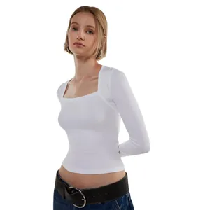 Macro detail of white ribbed long sleeve top featuring a sexy square neckline on model
