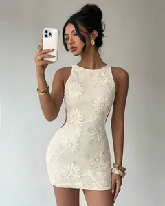 Detailed view of white lace floral embroidery and sequins on backless party mini dress