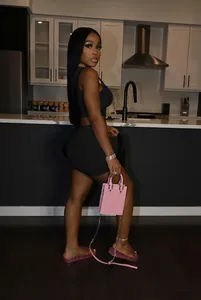 Detailed lifestyle shot of a woman wearing a black two-piece tank top and short set.