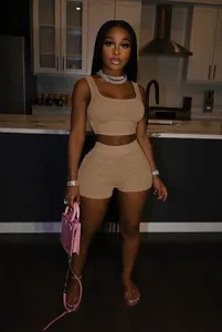 Full view of women's tan two-piece crop top and high-waist shorts casual sporty set