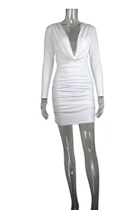 Close-up of white ruched long sleeve mini dress with deep V-neck and bodycon fit.