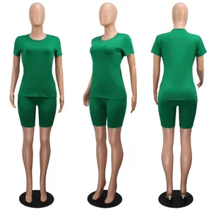 Detail views of green two-piece athletic set featuring round neck tee and biker shorts