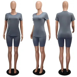 Front, side and back view of grey short sleeve T-shirt and biker shorts set on mannequin.