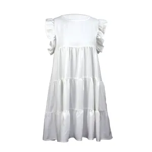 Close-up of white tiered dress featuring ruffled flutter sleeves and pleated layers.