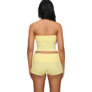 Back view of a yellow cotton two-piece yoga set with tube top and fold-over shorts