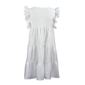 Close-up detail of a white tiered summer dress featuring elegant ruffle sleeves.