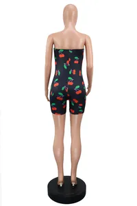 Back view of women's sexy strapless romper with vibrant cherry print on black background