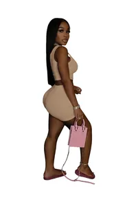 Full view of the two-piece tan leisure sports set featuring a crop top and mini shorts.