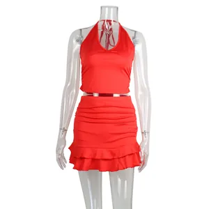 Red halter neck backless top and ruffled mini skirt two-piece set on mannequin
