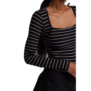 Close-up of a ribbed striped long-sleeve shrug top with a sexy low square neckline.