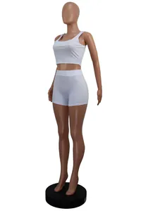 Detailed side view of white ribbed two-piece sports set with crop top and shorts.
