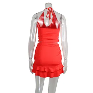 Detailed back view of a sexy red halter backless top and ruffled skirt set on mannequin