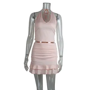 Elegant pink two-piece set featuring a sexy halter neck crop top and a ruffled mini skirt