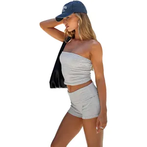 Detailed view of grey cotton slim fit yoga shorts and tube top set styled on a model