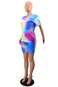 Side view of women's vibrant tie-dye two-piece set with V-neck top and biker shorts