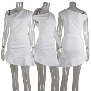 Detailed view of a white one-shoulder dress with pleated ruffles and an irregular hem line
