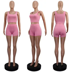 Women's pink ribbed two-piece leisure set with crop top and shorts from three views
