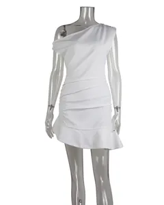 Elegant detail of a white one-shoulder mini dress with pleated waist and ruffled hem